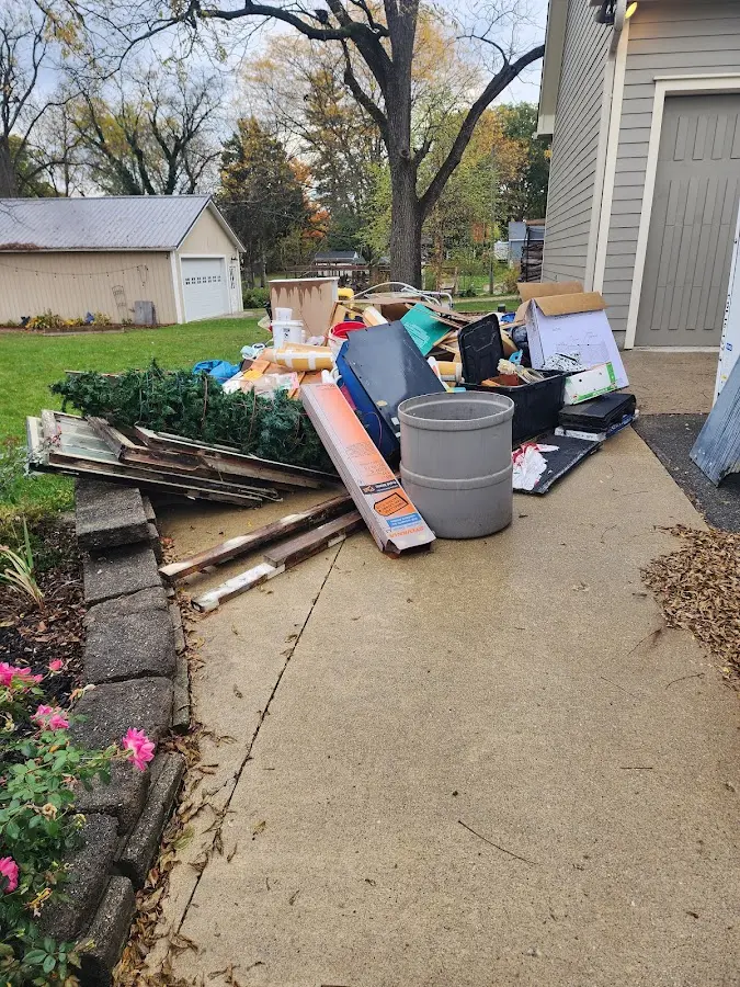 Dumpster being loaded with debris for 10 Yard Dumpster Rental in Valley Stream